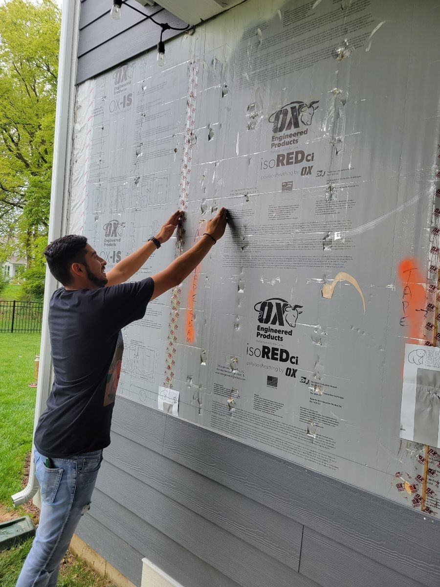 Blaze Renovations LLC contractor installing vinyl siding