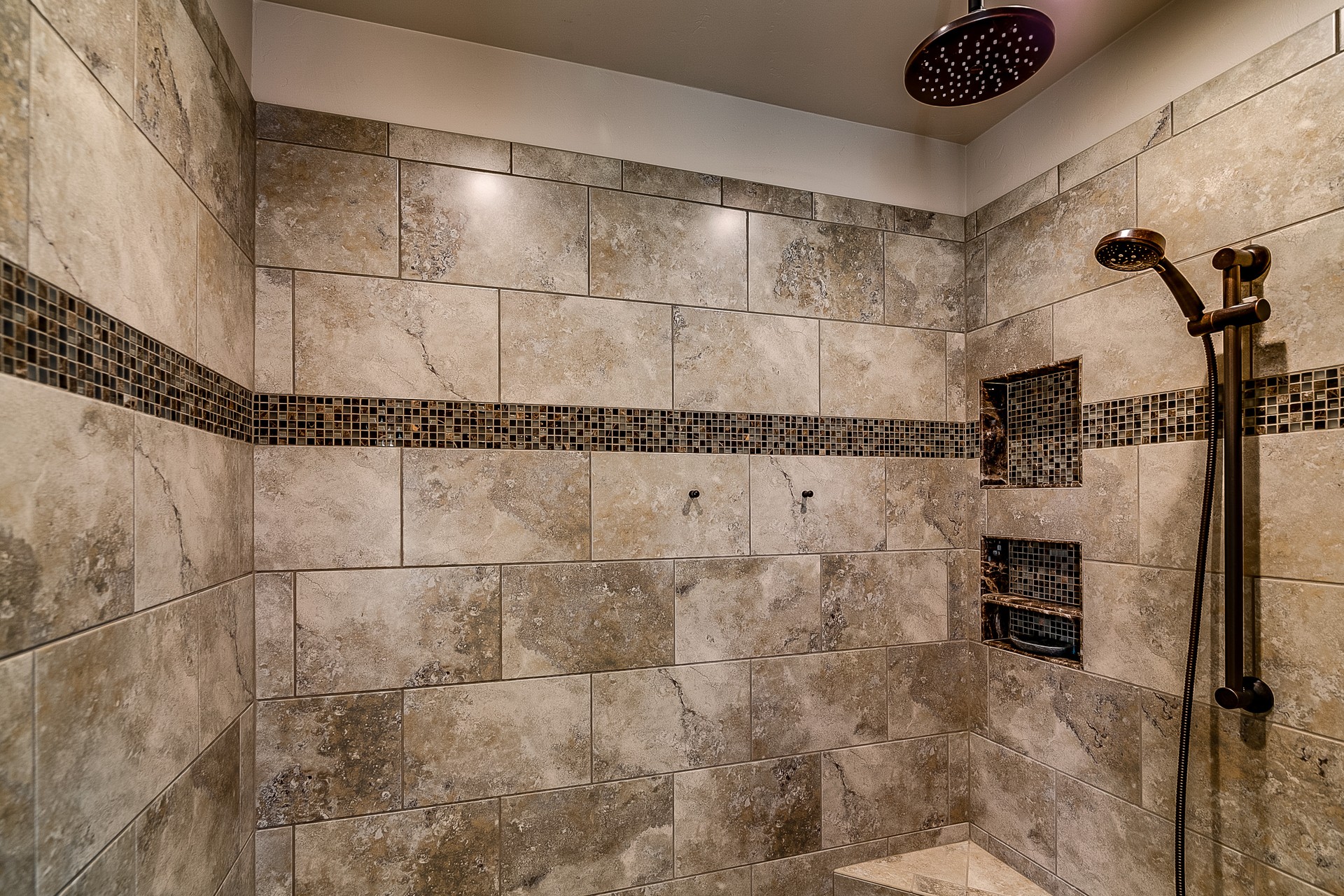 Spacious shower with gray colored tiles